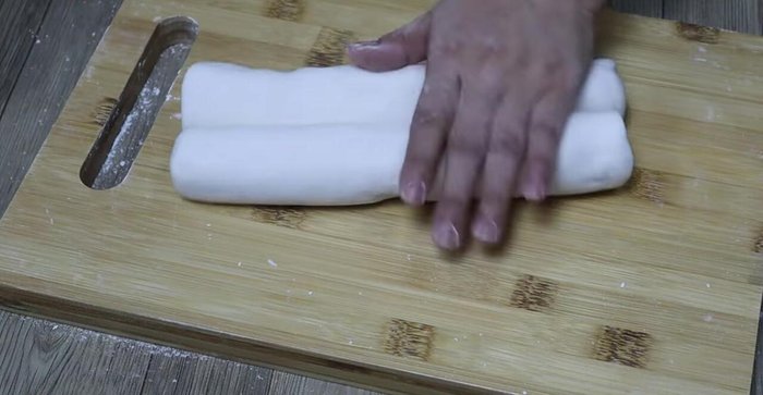 Divide the dough into portions. Roll out and cut into noodles. Dust with dry flour to prevent sticking.