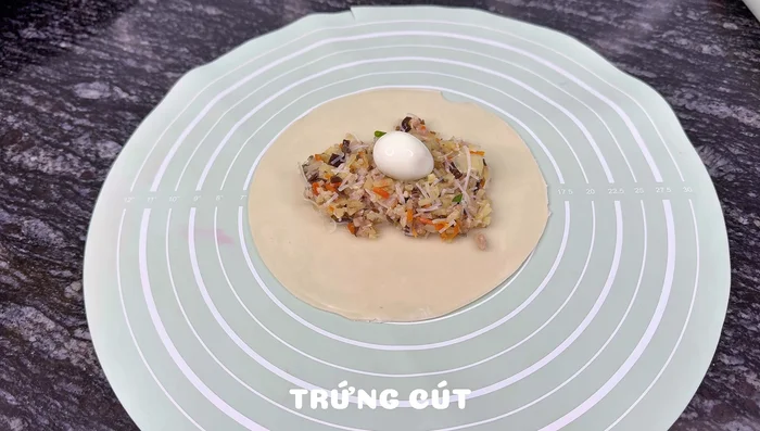 Assemble the Banh Quai Vat: Place filling and a quail egg (or other egg) in the center of each dough circle. Fold the dough over and pinch the edges to seal.