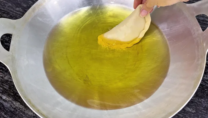 Fry the Banh Quai Vat: Heat oil in a pan and fry the Banh Quai Vat over medium heat, turning frequently until golden brown.