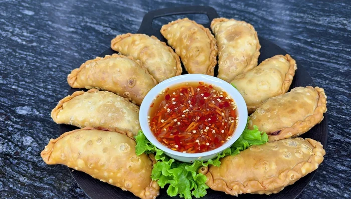 Serve: Arrange the fried Banh Quai Vat on a plate and drizzle with fish sauce.