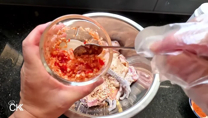 Mince or finely chop garlic, shallots, and chili. Mix half with the chicken for marinating, and reserve the other half for later. (109.56)