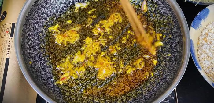 Sauté onions in cooking oil and annatto oil until fragrant and golden. Add washed straw mushrooms and stir-fry until clear. Add seasoning powder, rock sugar, and fish sauce. Stir well and turn off the heat.