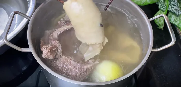 Once the beef is soft, scoop it out into a bowl of cold water to prevent it from turning black.