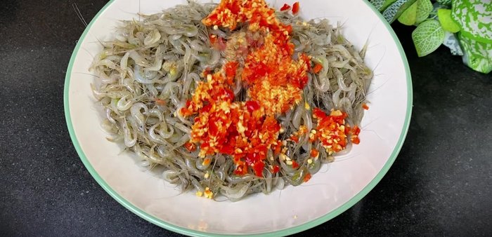 In a bowl, mix the drained shrimp with the garlic-chili paste, 1 tablespoon of salt, 2 tablespoons of white wine, and the cooled fish sauce mixture.