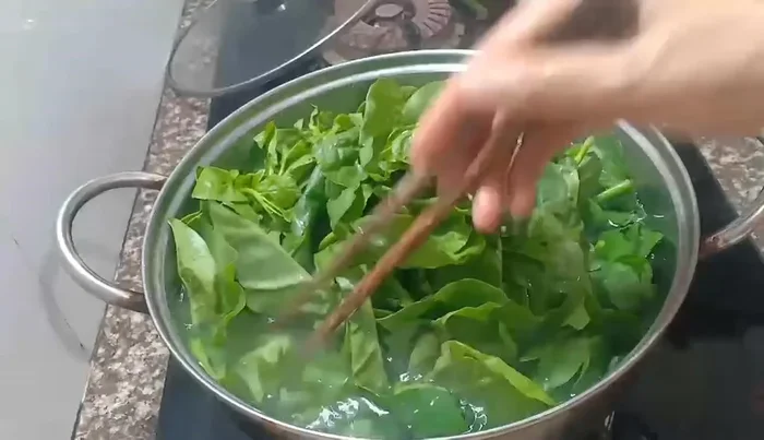 Add the Malabar spinach to the boiling water. Use high heat when boiling vegetables.