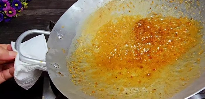 Reduce heat to medium-low, stirring to ensure the sauce coats the cockles evenly. Continue cooking until the sauce is thick and sticky, with minimal bubbling.