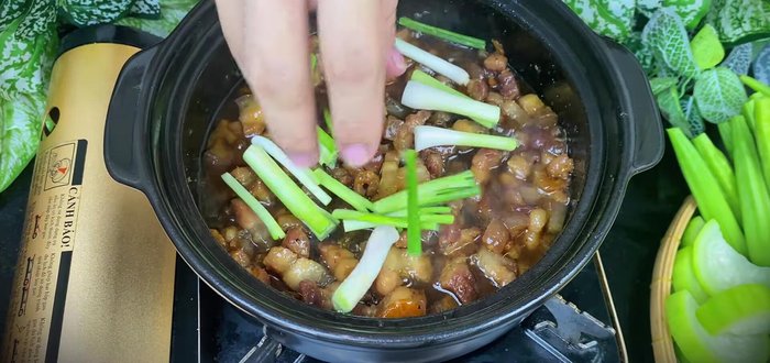 Once the sauce has thickened, add spring onions and chili. Stir and serve hot with the boiled vegetables and rice.