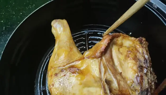 Grill the chicken at low heat, occasionally spraying with a little water to prevent drying.