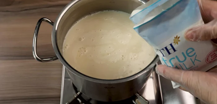 Add ginger juice and 2 packs of unsweetened fresh milk to the soy milk mixture. Stir until heated through.