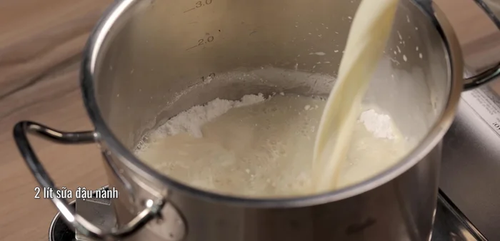 Add soy milk to the mixture and stir continuously over medium-low heat.