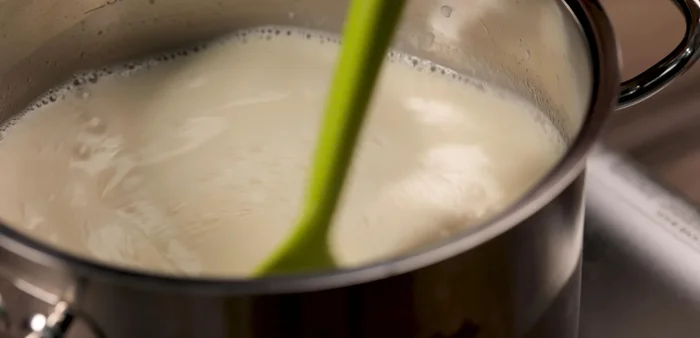 Bring the mixture to a boil and simmer for about 5 minutes, adding pandan leaves for fragrance if desired.
