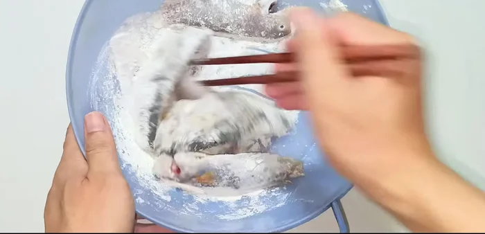 Coat the fish evenly with the flour mixture, ensuring a thin layer.