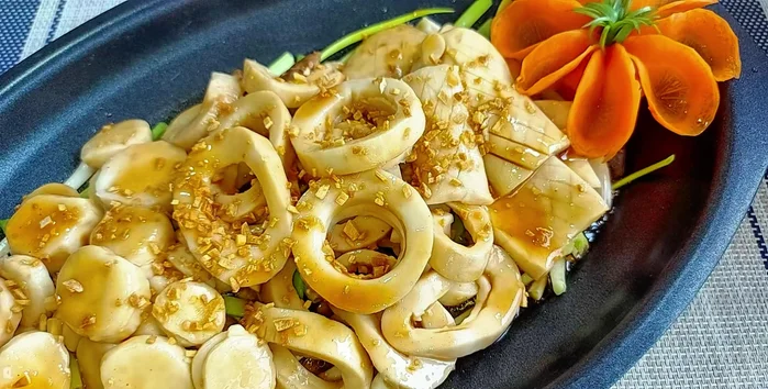 Garnish with fried garlic and a carrot flower.